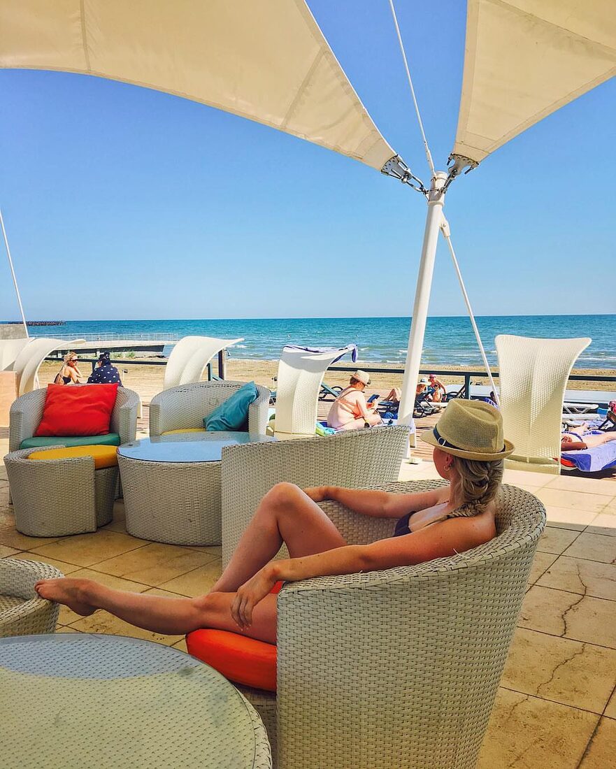 Loungers and parasols on the resort's private Caspian beach